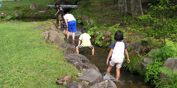 小川で遊ぶ子供